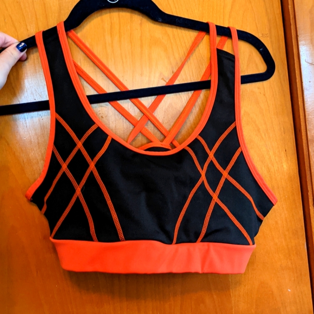 Orange and black racer back sports bra